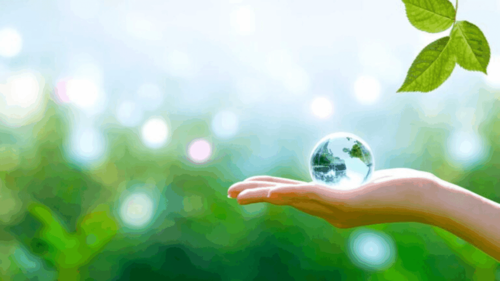 On a verdant nature setting, a woman delicately embraces the transparent globe of Earth in her hand